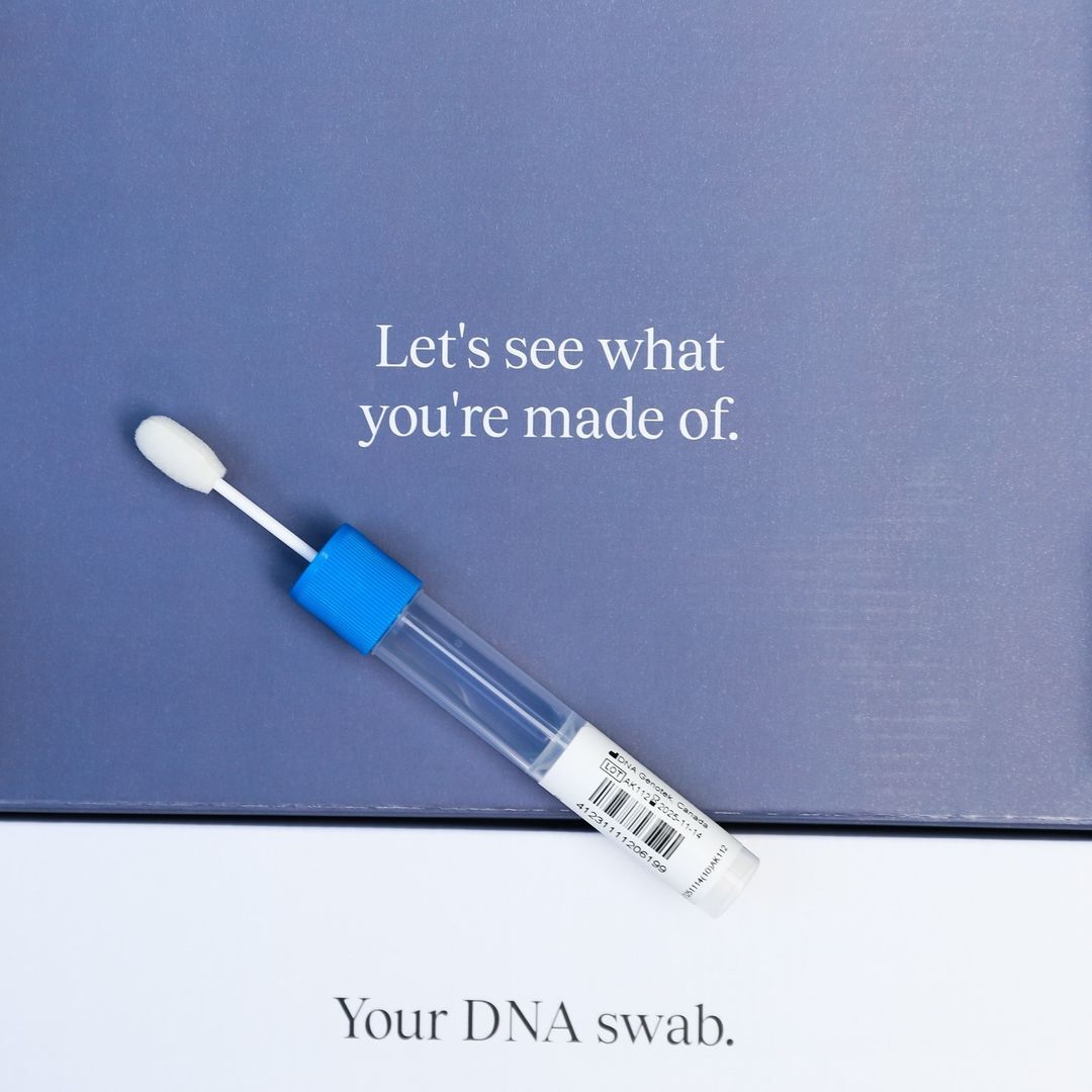 Stride DNA collection swab in a clear tube with a blue cap, resting on a slate blue box printed with the words Your DNA swab