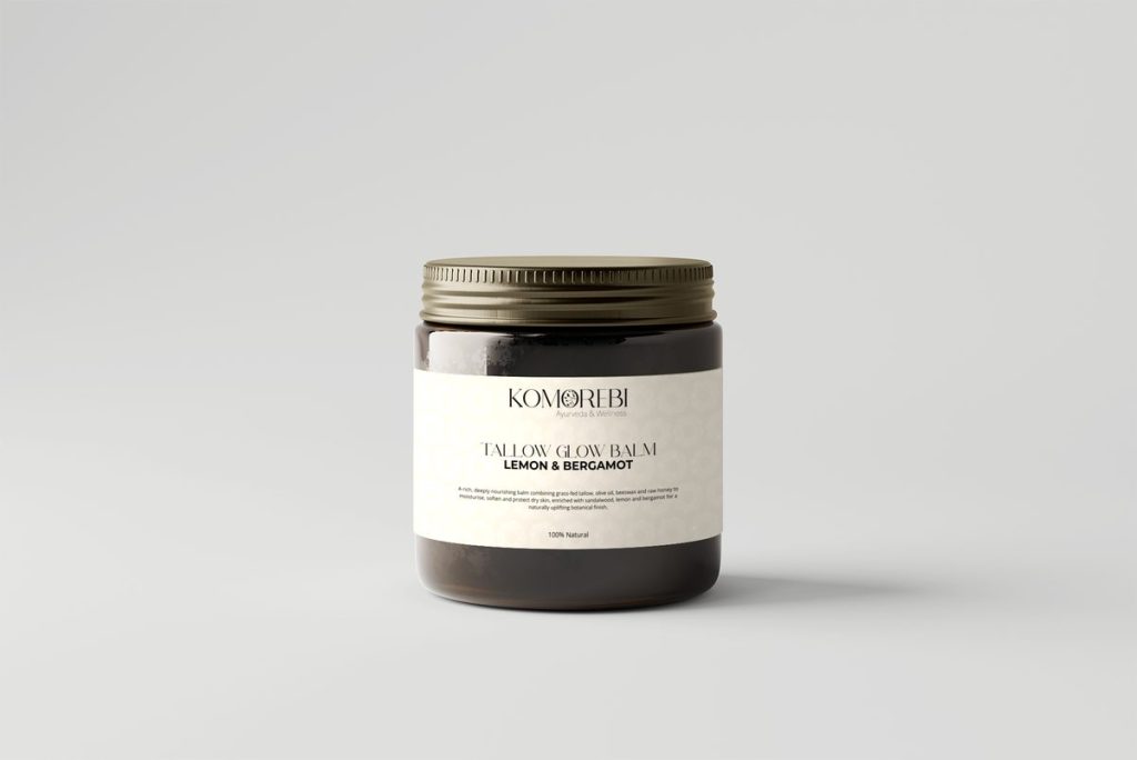 Komorebi Tallow Glow Balm 100ml in an amber glass jar with a gold lid, Lemon & Bergamot label