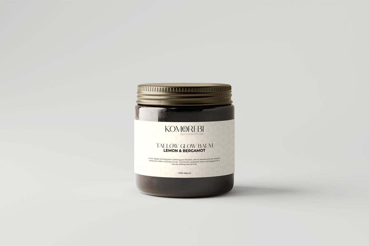 Komorebi Tallow Glow Balm 100ml in an amber glass jar with a gold lid, Lemon & Bergamot label